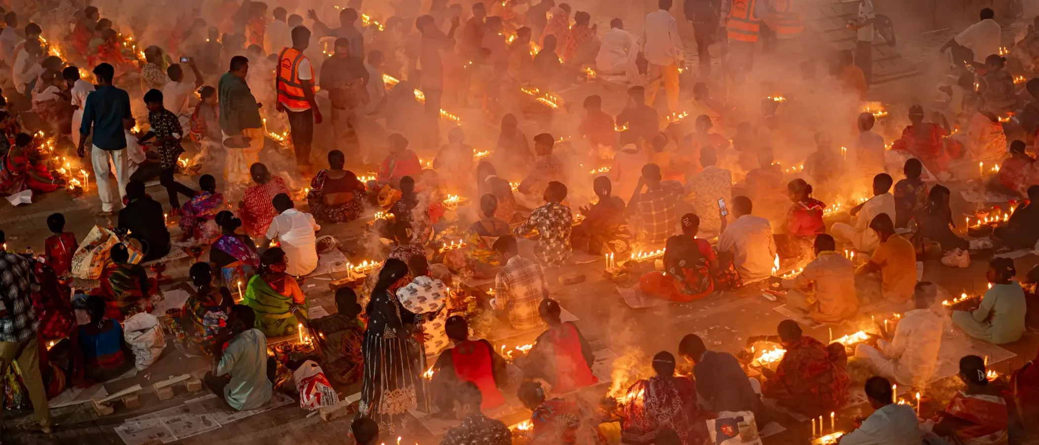 Devotees surrounded by oil lamps and incense during Rakher Upobash in Barodi, Bangladesh